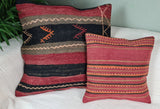 Zwei orientalische Sofakissen mit rot und schwarzen Streifen auf sofa